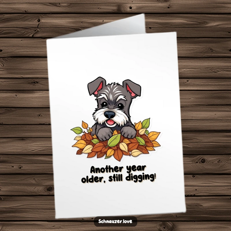 Funny Free Printable Birthday Card: Schnauzer playfully digging in a pile of leaves, celebrating.