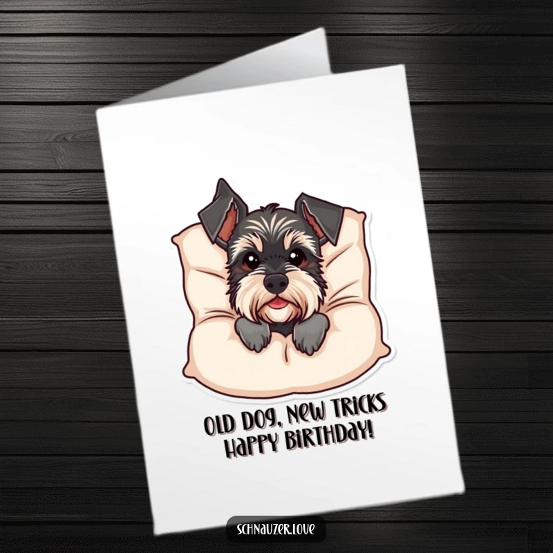 Funny Free Printable Birthday Card: Schnauzer peeking coyly from behind a plush cushion, ready to deliver birthday wishes.