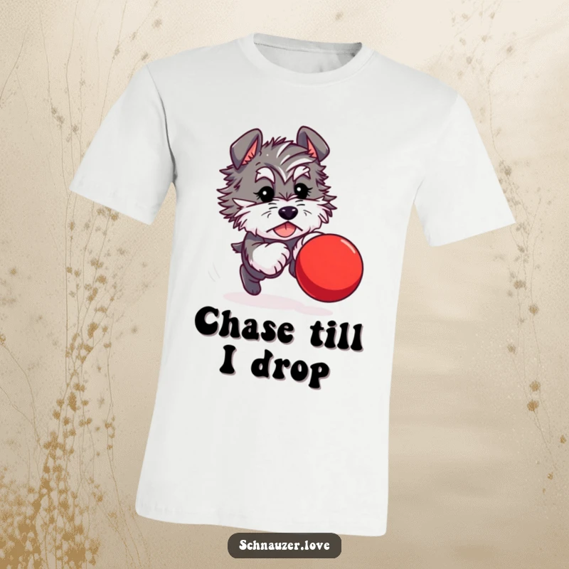Funny t-shirt graphic of a fluffy schnauzer character sprinting after a vibrant red, bouncing ball, full of playful energy.