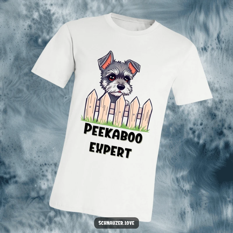 Funny T-Shirt depicting a small schnauzer with expressive eyes peeking over a tiny fence with great interest.