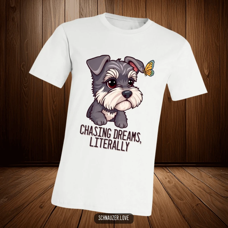 Funny Schnauzer T-Shirt: A schnauzer with bright, focused eyes watches a butterfly flutter by, creating a humorous and endearing scene. Great funny gift.