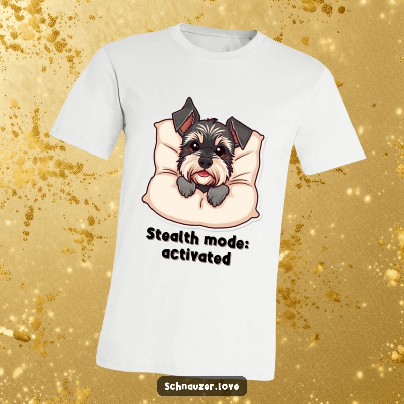 Funny Schnauzer T-Shirt: A mischievous schnauzer peeks from behind a large, soft cushion, offering a humorous and heartwarming surprise. Ideal funny gift.