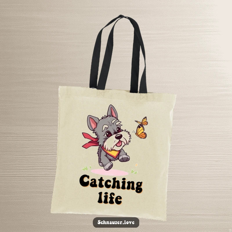 Funny tote bag showcasing a bandana-clad schnauzer joyfully chasing a butterfly, ideal for carrying daily items with a dose of humor.